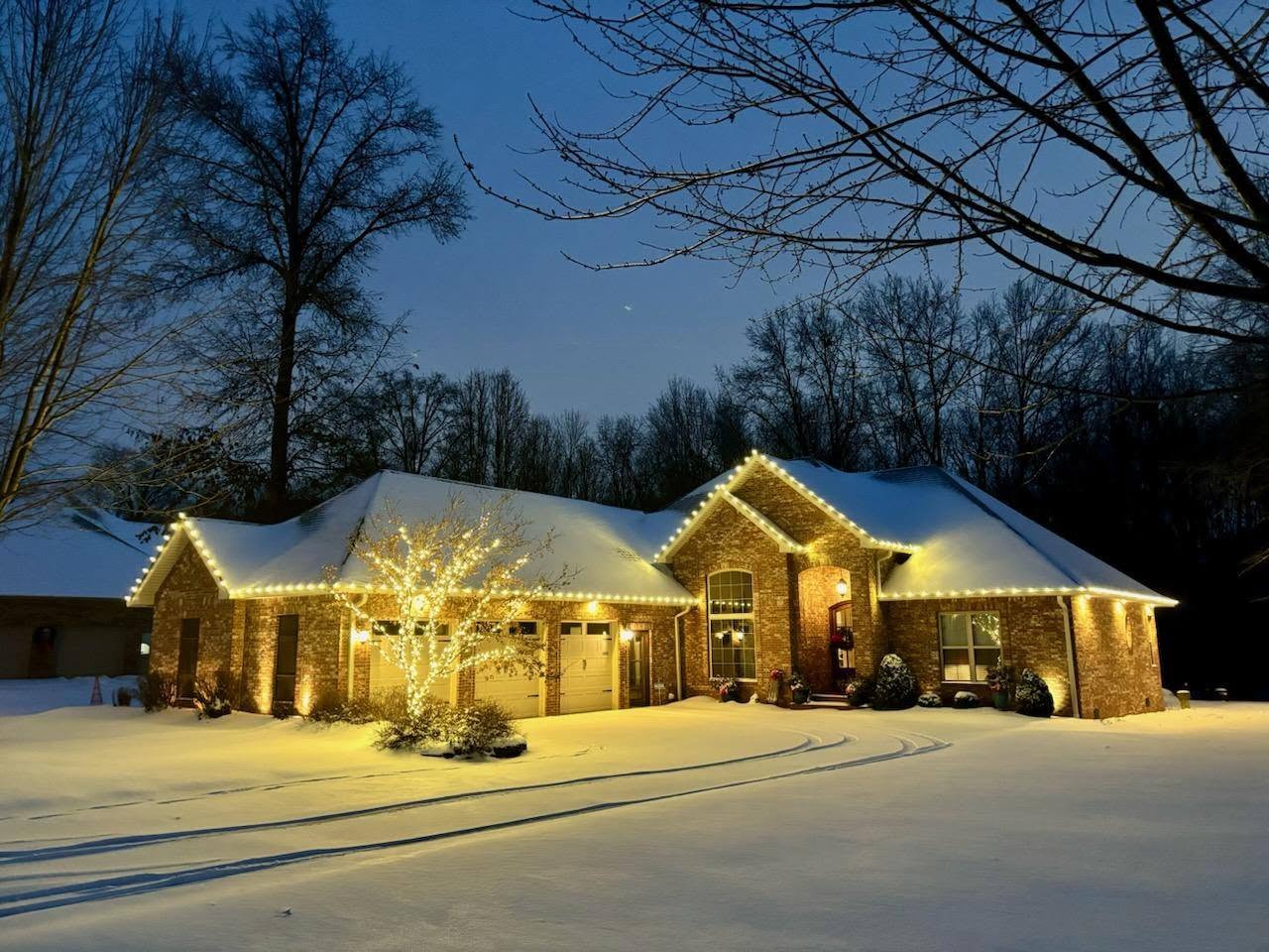 Southern Illinois home decorated with vivid blue and warm white lights