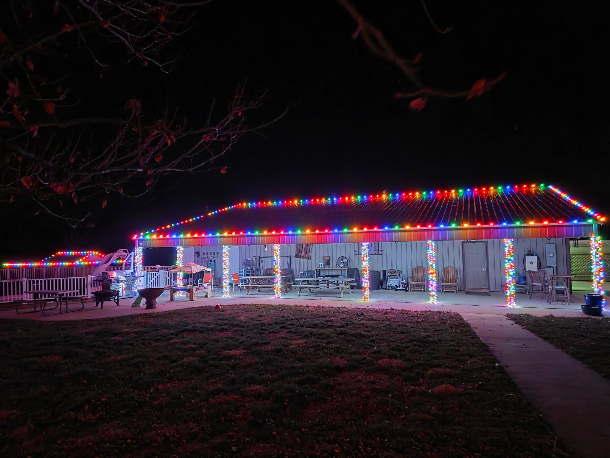 Building with multicolor roofline lights and wrapped patio columns