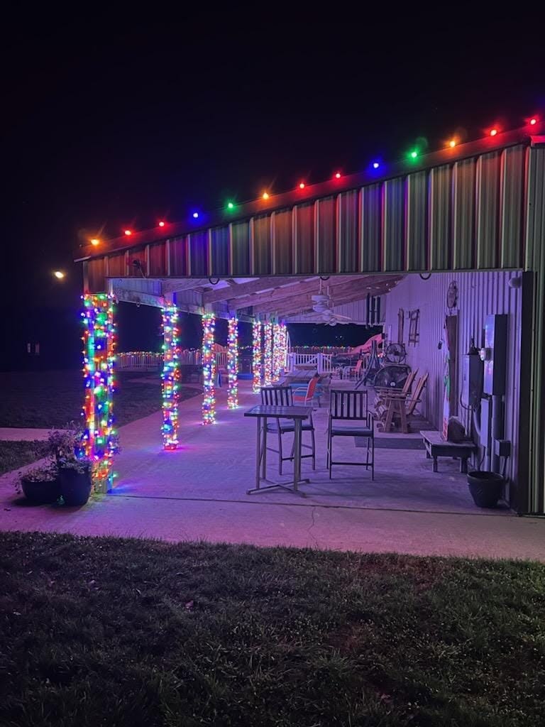 Covered patio columns wrapped in multicolor holiday lights